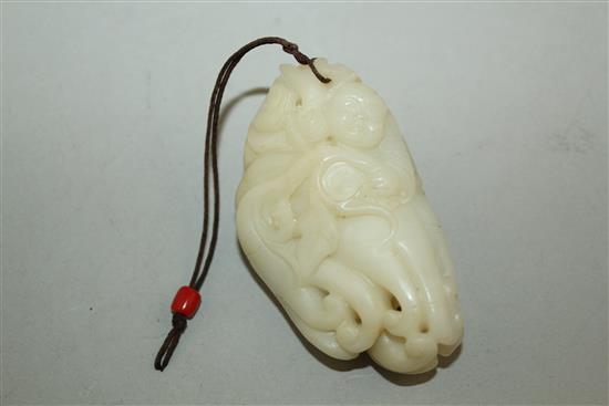 A Chinese white jade carving of a boy clambering on a finger citron, 7.7cm